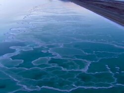 AERIAL MS CU DS  View of salt crystals in dead sea / Sourn Judea Desert, Israel   Stock Footage