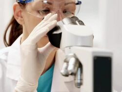Female Scientist Working With Microscope Stock Footage