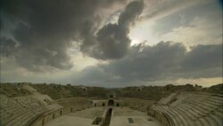 Storm clouds loom over the ruins of the Oudna Amphitheater in Tunisia. Stock Footage