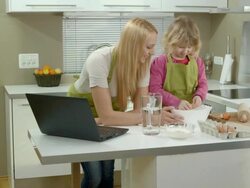 HD DOLLY: Mother Teaching Daughter To Cook Stock Footage