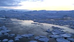 Clouds drift above floating sea ice in Greenland. Stock Footage