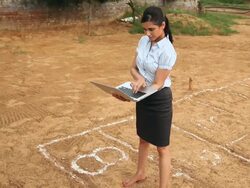 Businesswoman working on a laptop and playing hopscotch, Haryana, India Stock Footage