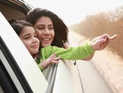 Woman with her daughter watching from window of a car  Stock Footage
