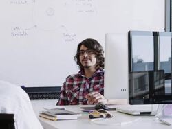 MS young businessman in discussion at desk in high tech start up office with mature businessman Stock Footage