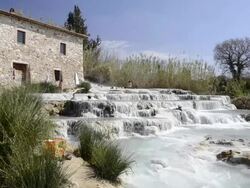 MS Shot of People relaxing in hot spring, thermal pools of sulphurous water / Saturnia, Tuscany, Italy Stock Footage