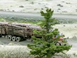 WS TS ZO View of logging truck traveling through grasslands / Williams Lake, British Columbia, Canada Stock Footage