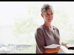 MS smiling businesswoman looking at notepad laughing during meeting with coworker in office. Stock Footage
