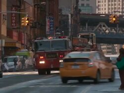 A New York City Fire truck speeds around the corner and drives up Madison Street to an emergency Stock Footage