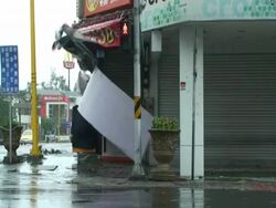Sign comes loose and flies towards camera, almost hitting cameraman; Typhoon Morakot, Taiwan 7th August 2009 (With Audio) Stock Footage