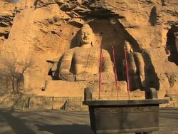 WS POV Shot of big Buddha sutra carving and square censer in front of Yungang Grottoes / Datong, Shanxi Province, China Stock Footage