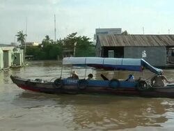 TS Small boat travelling the Mekong River near Saigon / Vietnam Stock Footage