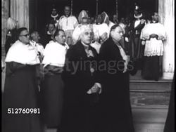 1940s: VATICAN CITY: SAINT PETER'S BASILICA: CATHOLIC CLERGY: VS Ordained Catholic clergymen walking out of church, deacons, priests, bishops escorted by Swiss Guard. Instructional Video
