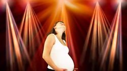 A young pregnant woman dances in front of a light show. Stock Footage