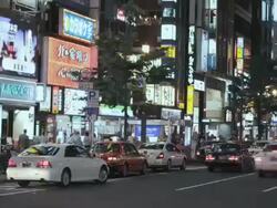 WS T/L View of busy street with traffic and neon signs near Shinjuku station / Shibuya, Tokyo, Japan Stock Footage