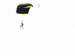 BASE jumper/wing suit flier descends from cliff Stock Footage