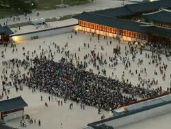 WS View of People roaming at Gyeongbokgung Royal Palace at sunset / Seoul, South Korea  Stock Footage