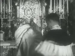 MOT 1933: EUROPE: CATHOLICS: HA WS Catholic church alter w/priest & alter boys FG, Priest (or higher rank) holding, raising very ornate pastoral staff (crosier). GERMANY: NAZI PROPAGANDA: CU Anti-Semitic Juden poster w/ illustration of Jewish man Instructional Video