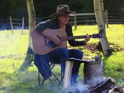 Cowgirl playing Guitar around campfire and Cowboy riding horseback Stock Footage