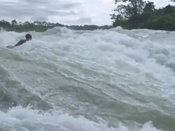 MS PAN SLO MO Man swimming in waterfalls / Jinja, Uganda Stock Footage