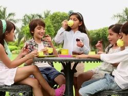 Group of kids drinking tea in the lawn  Stock Footage