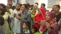 Defiant devotees celebrate saint's birthday at massacre site News Clip