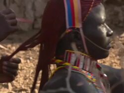 Maasai Ceremony - Young man combing young warrior's hair, WITH AUDIO Stock Footage