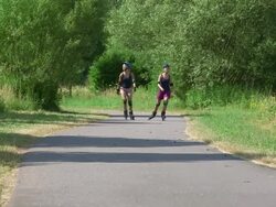 WS Shot of girls skating with rollerblades on bicycle lane / Ockfen, Rhineland Palatinate, Germany Stock Footage