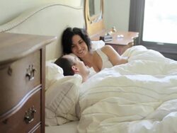 Husband and wife having lie in in bed Stock Footage