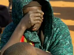 Refugee woman holding child on her lap Stock Footage