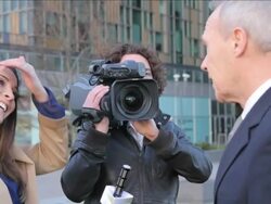 Female newsreporter on location interviewing executive Stock Footage