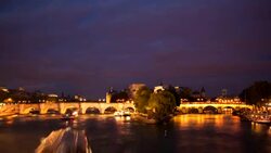 The brightly lighted Pont Neuf bridge spans the Seine River. Stock Footage