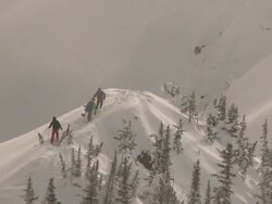 skiers and snowboarder hike to peak / golden, british columbia, canada Stock Footage