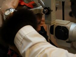 Child at Optometrist Eye Check Up in Dark Room Stock Footage