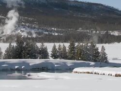 WS PAN Snowy forest landscape with river / Yellowstone National Park, Wyoming, United  Stock Footage