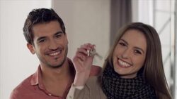 Couple posing with key in new apartment Stock Footage
