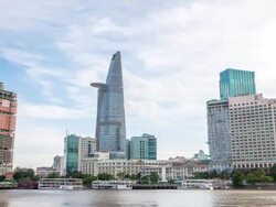 WS T/L View of bitexco tower with Renaissance hotel and boat restaurants across Saigon river / Ho Chi Minh City, Southeastern, Vietnam Stock Footage