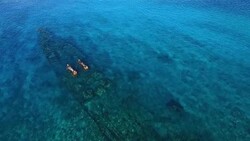Pull back over WWII ship wreck SS President Taylor on Kanton Island Stock Footage
