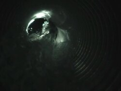 CU SLO MO Shot of cross section of water as it gushes down pipe / United Kingdom Stock Footage