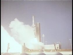 An explosion of smoke accompanies the launch of a rocket. News Clip