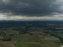 AERIAL WS Storm clouds hovering over landscape east of Vienne / Isere, France Stock Footage
