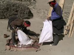 MS Opening bag of tibetan salt / Saldang village, High Himalayas, Upper Dolpo near Tibetan border, Nepal Stock Footage
