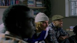 Group of young adult males on edge of seat watching sports on TV medium shot Stock Footage