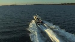 An MJM 40z powerboat speeds across Narragansett Bay towards the Newport Bridge. Stock Footage