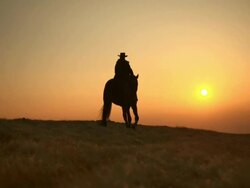 HD: Western Horseback Riding At Sunset Stock Footage
