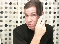 Man looking into camera brushing hair Stock Footage