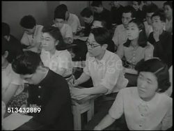 1946: JAPANESE EDUCATION: WS School campus, buildings, students (college, higher education). INT VS Young adult Japanese students in classroom, both male & female students, teacher talking. Occupied Japan, Democratization Instructional Video
