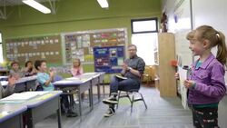 Classmates clapping for schoolgirl giving presentation Stock Footage