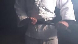 Judokas Fighter tying black belt Stock Footage