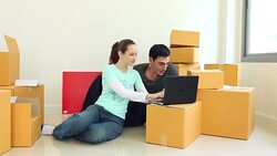 HD: Young couple using a credit card and a laptop to buy furniture for their new home Stock Footage