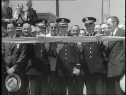 Three U.S. Military officers cut the ribbon at the opening of the Tacoma Narrows Bridge in Tacoma, Washington. Stock Footage